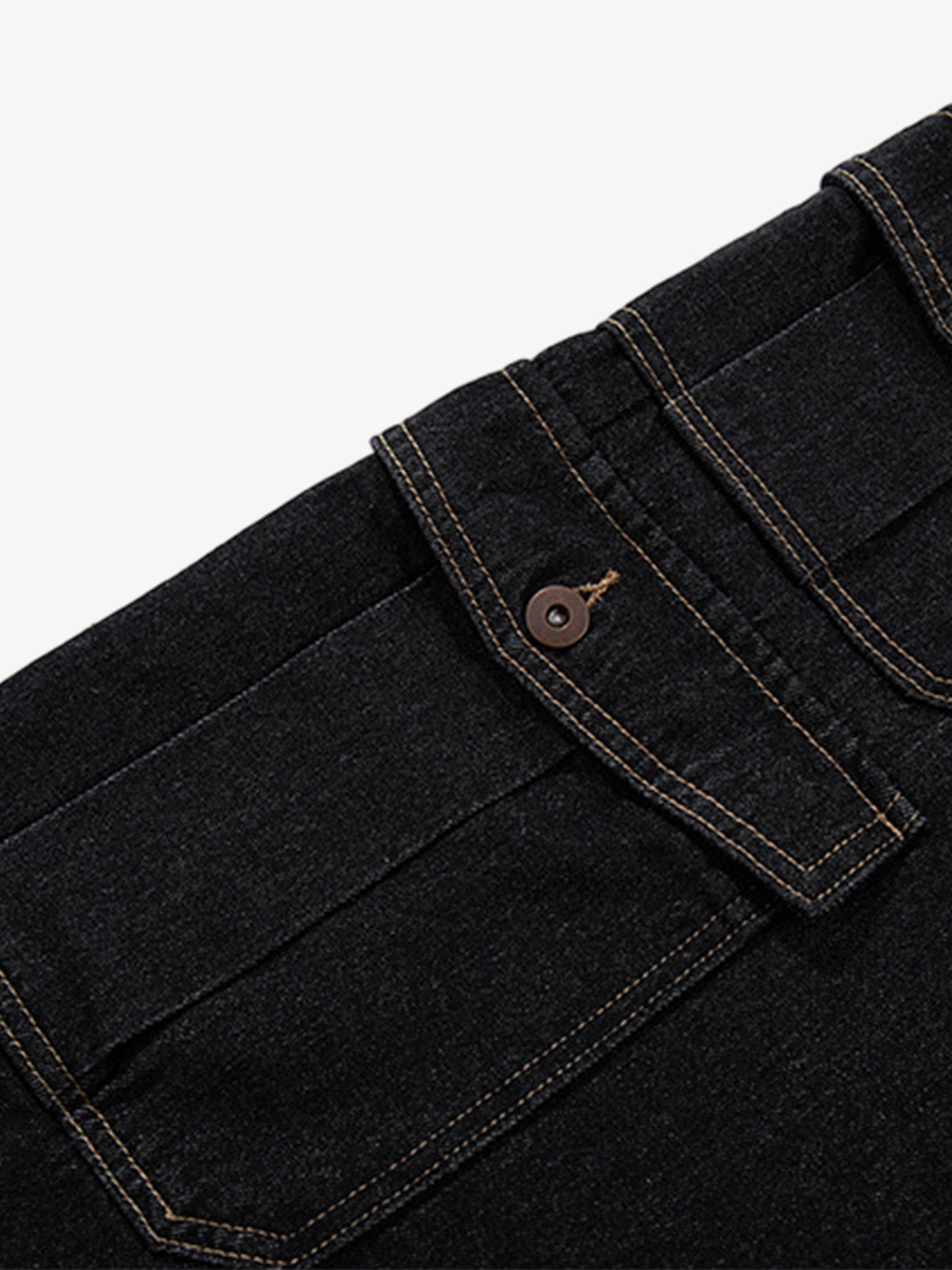Detail of copper button and zip fastening on dark wash denim shorts