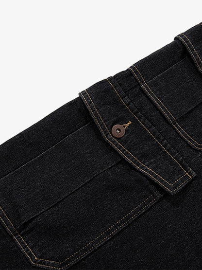 Detail of copper button and zip fastening on dark wash denim shorts