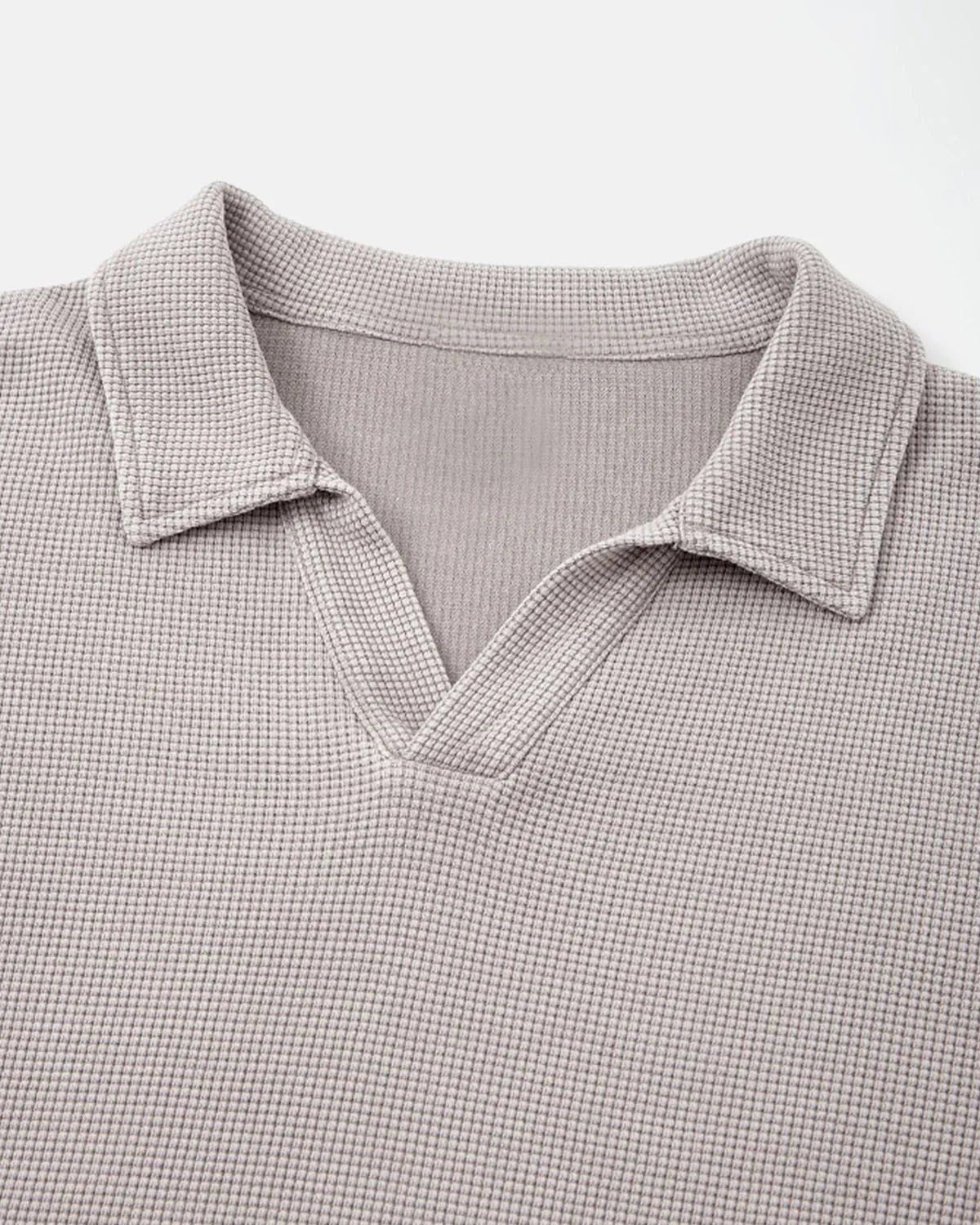 Detail of the collar and waffle texture on a washed polo shirt
