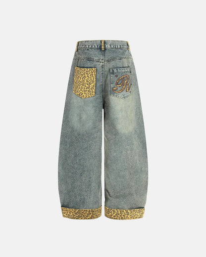 Back view of leopard patchwork jeans with embroidered accents
