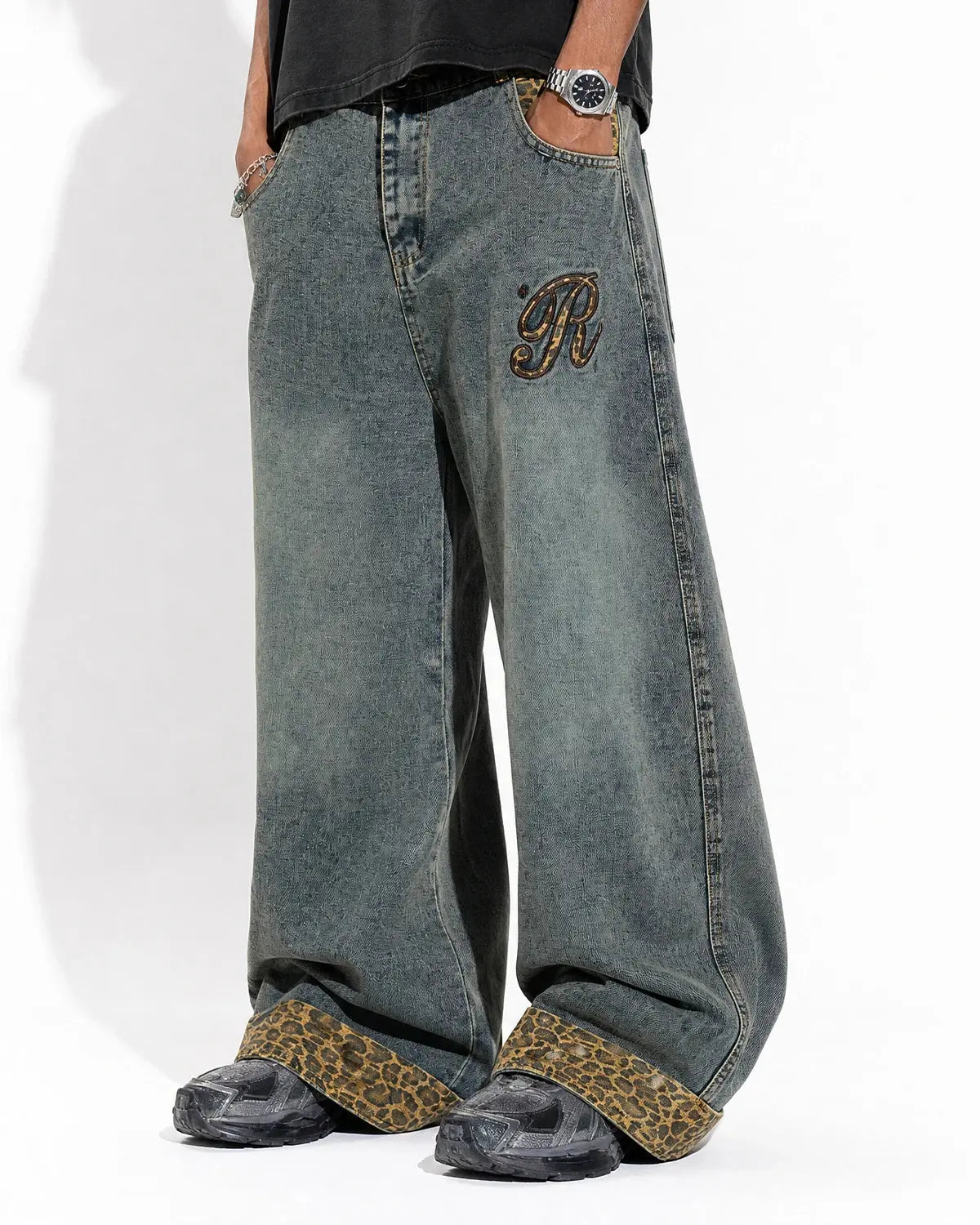 Close-up of embroidery on leopard patchwork denim jeans