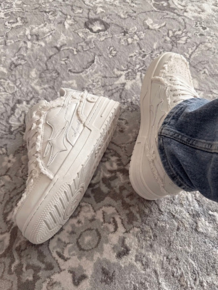 Cream lace-up sneakers displayed at a three-quarter angle