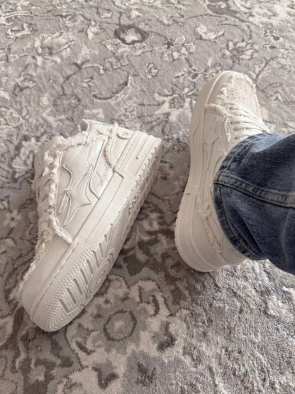 Cream lace-up sneakers displayed at a three-quarter angle