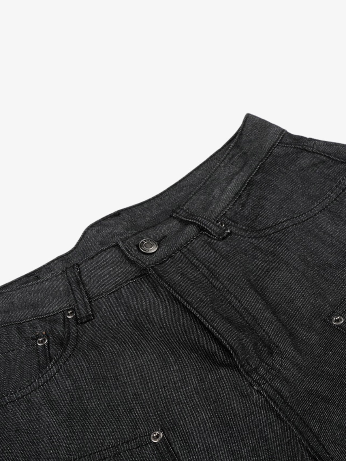 Black denim shorts styled on model with stud detail and patchwork