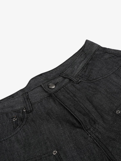 Black denim shorts styled on model with stud detail and patchwork