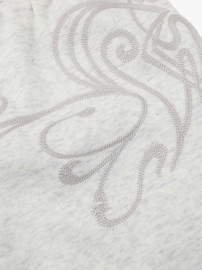 Close-up of graphic detail on men's sweat shorts