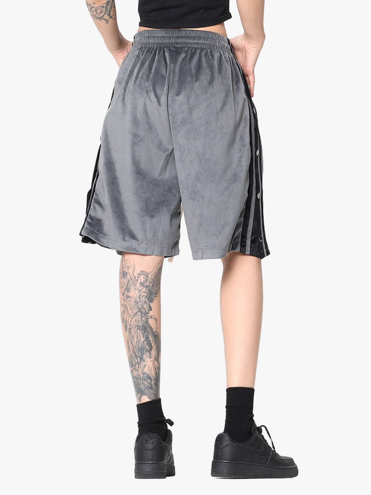 Side view of suede athletic shorts showing popper detail