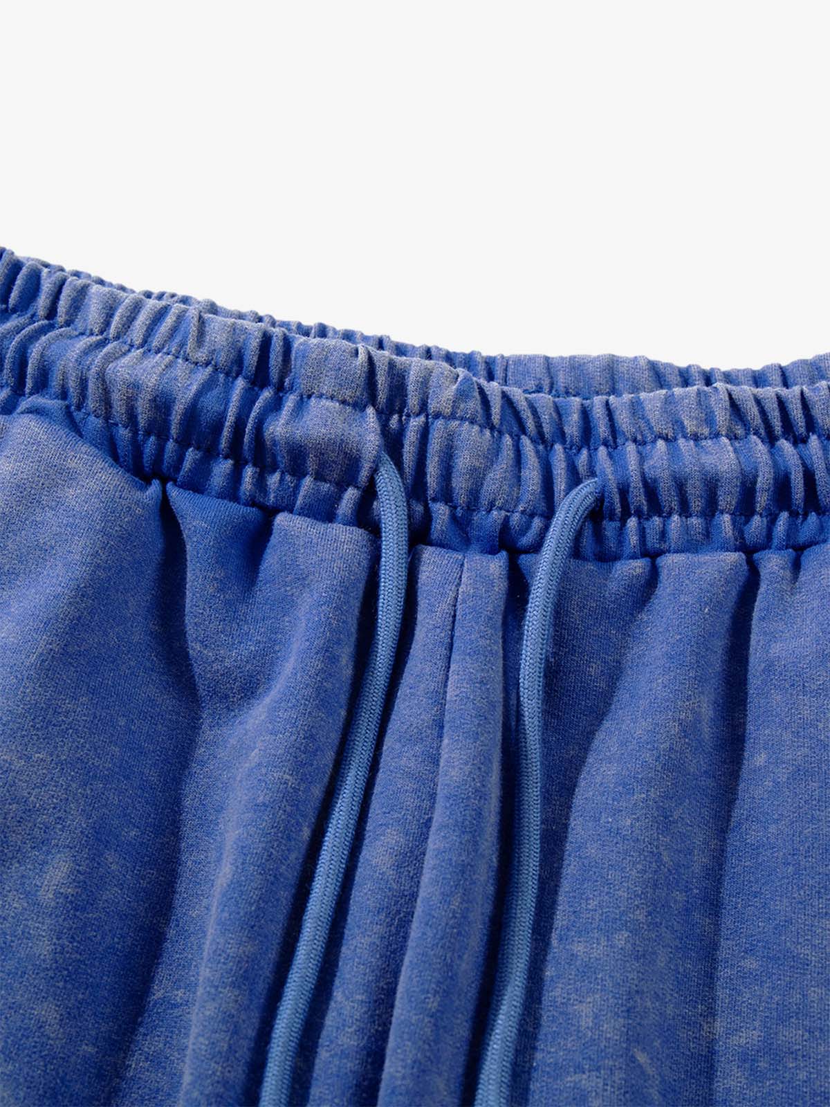 Textured close-up of rhinestones on women's distressed shorts