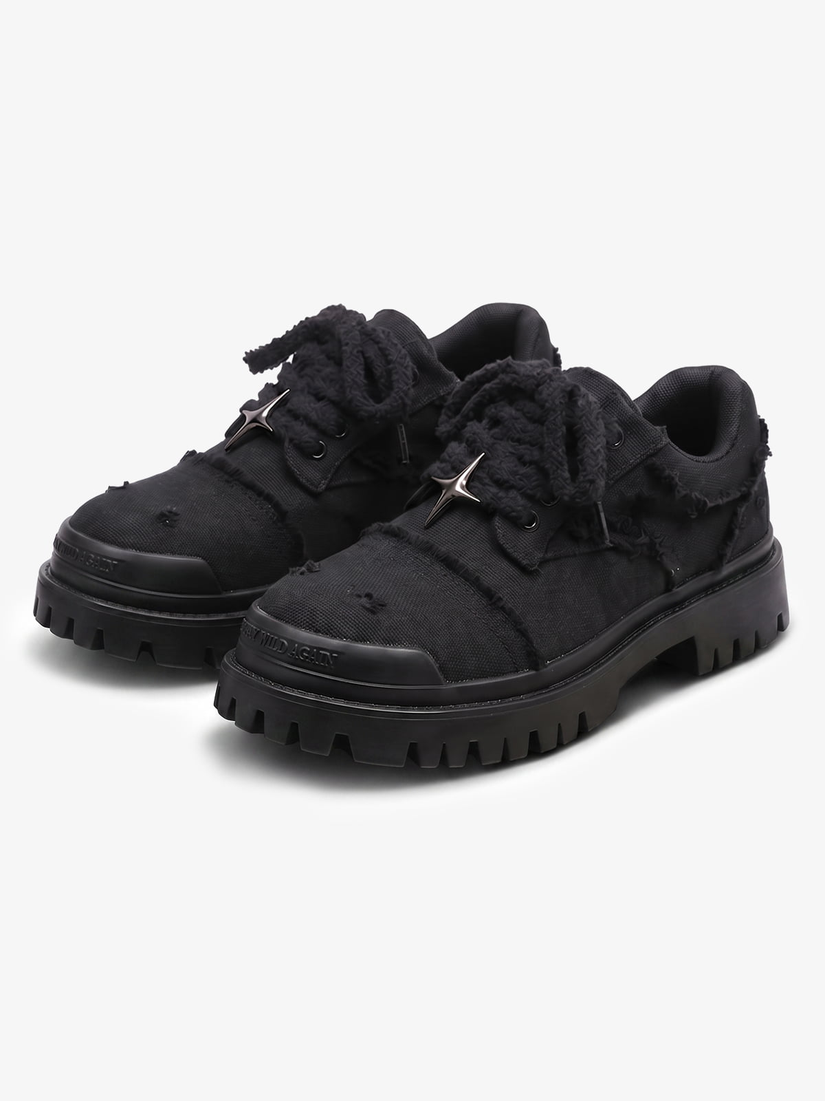 Black chunky platform trainers shown from the front with star eyelets