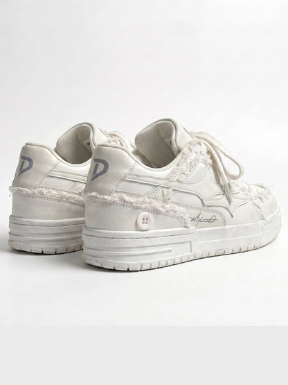 Cream trainers displayed as a matching pair
