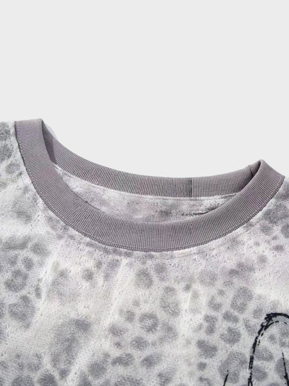 Side view of the distressed leopard print long-sleeve top