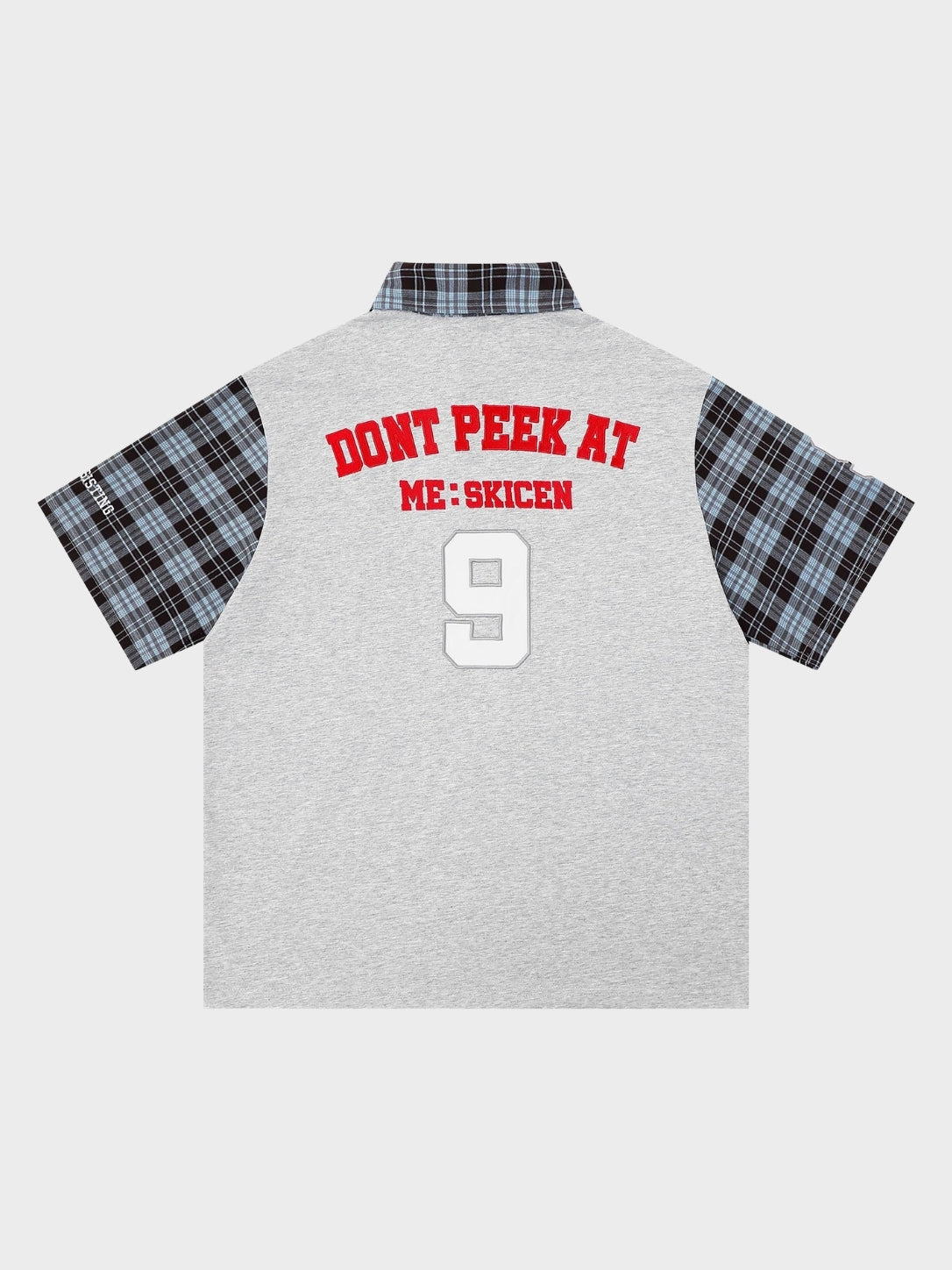Close-up of the plaid sleeve detail on the cotton polo shirt