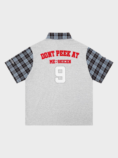 Close-up of the plaid sleeve detail on the cotton polo shirt