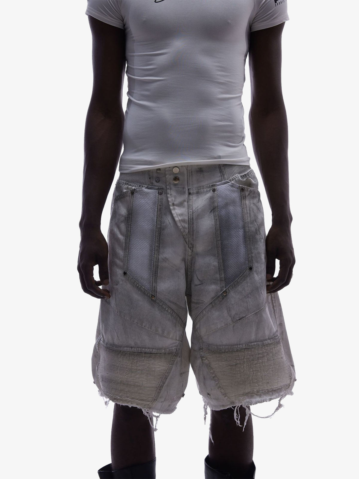 Back view of layered denim shorts with mesh panels in washed denim