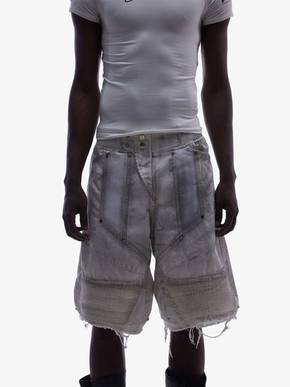 Back view of layered denim shorts with mesh panels in washed denim