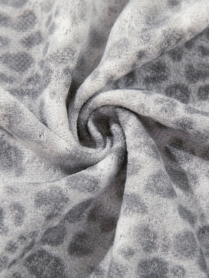 Full view of the distressed leopard print long-sleeve top