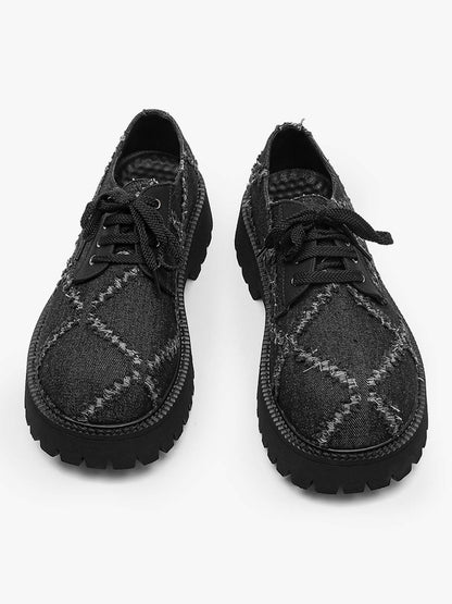 Rear view of chunky black derby shoes showing the platform heels