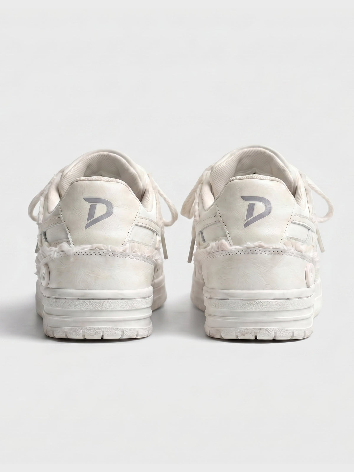Cream lace-up sneakers shown on a clean background