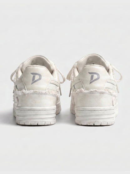 Cream lace-up sneakers shown on a clean background