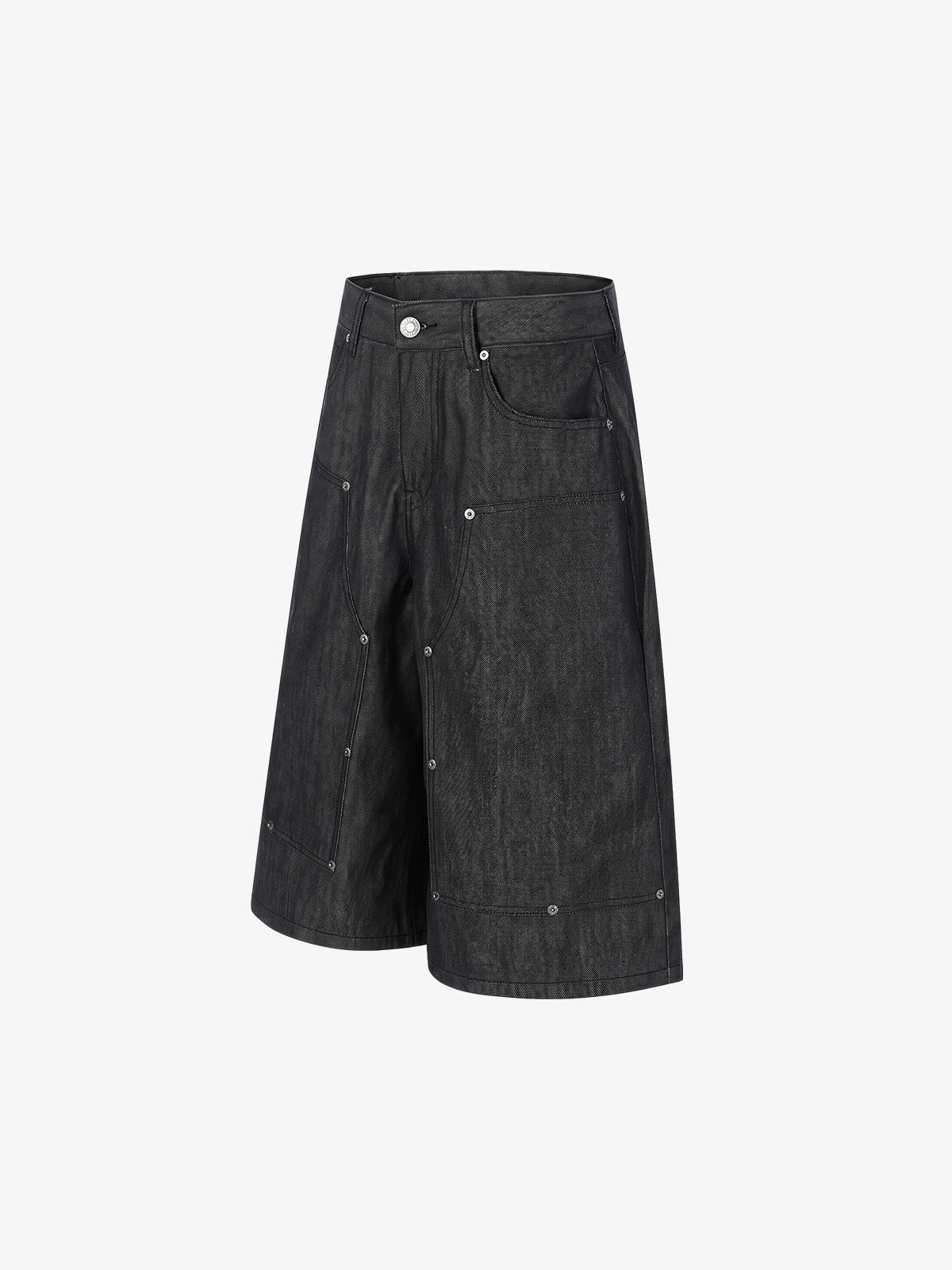 Side view of black denim shorts showing stud detail and patchwork design