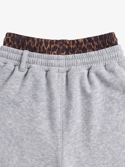 Full-length laid-flat view of heathered cotton-blend jogger shorts