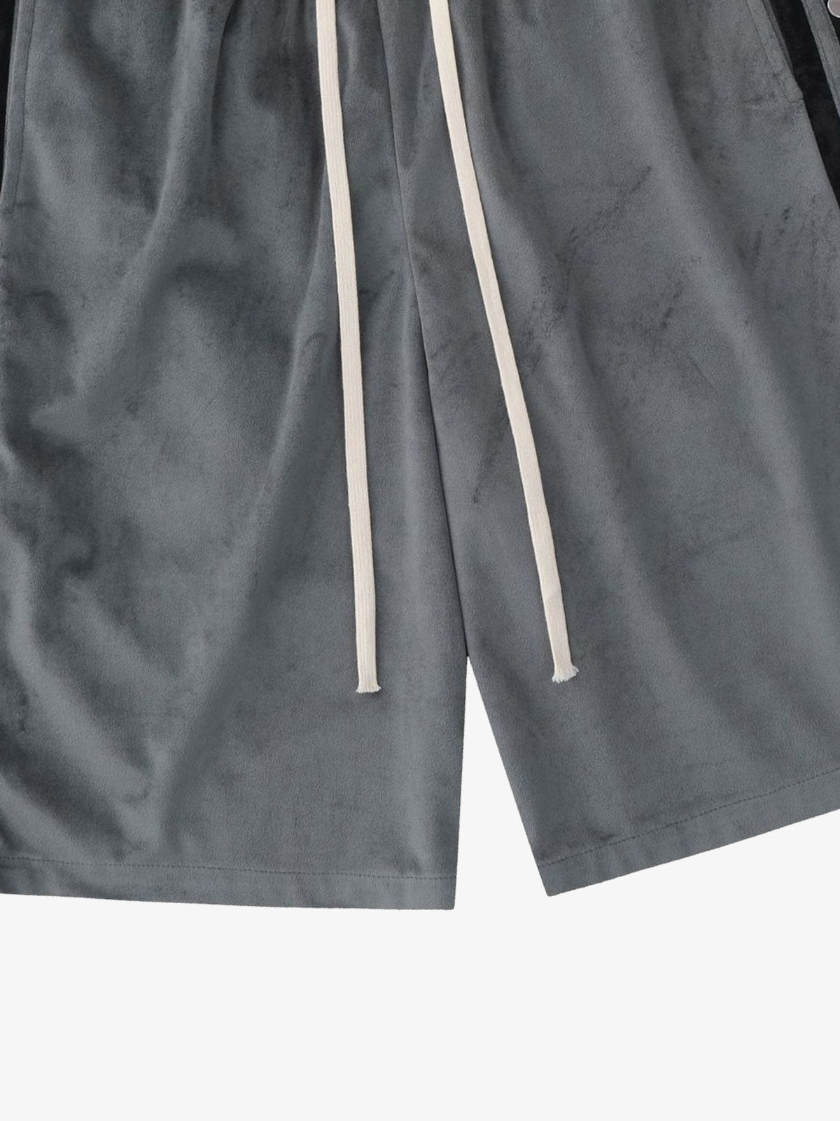 Model wearing suede athletic shorts with side popper detail