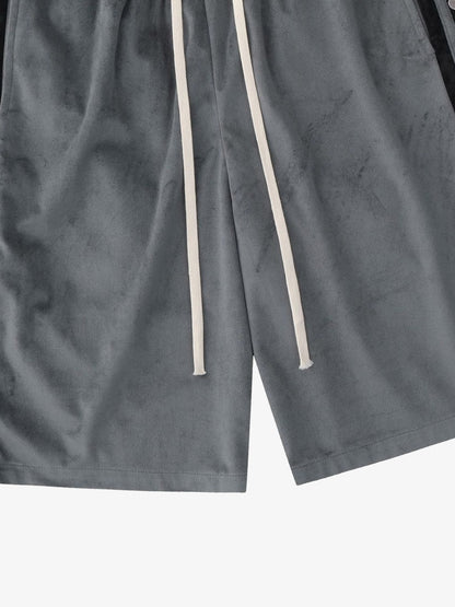 Model wearing suede athletic shorts with side popper detail