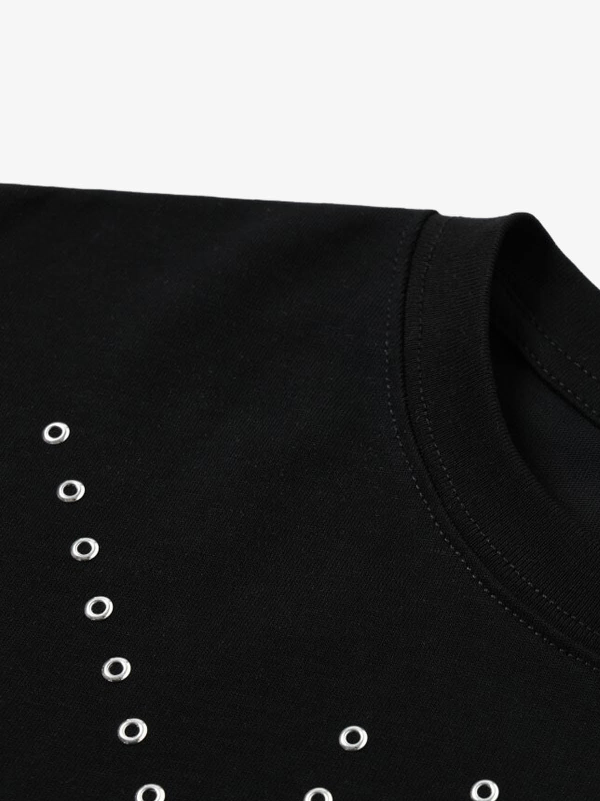 Close-up of silver grommet detail on black cotton T-shirt
