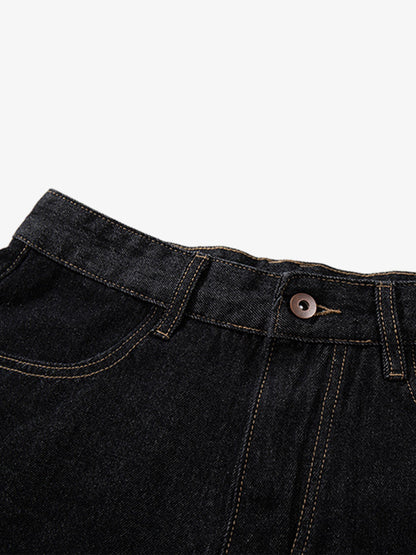 Close-up of adjustable waist tabs on dark wash denim shorts