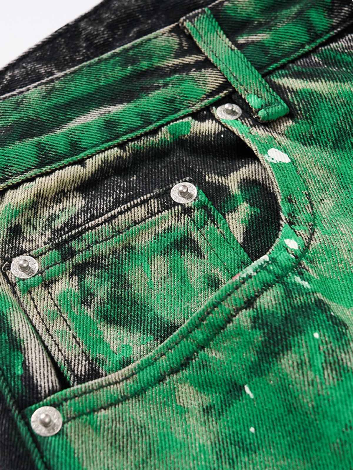 Close-up of paint-splatter detailing on denim jeans