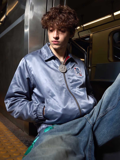 Close-up of the embroidered badge detail on the varsity jacket
