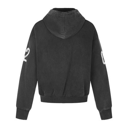 Close-up of the distressed number graphic printed on the hoodie front