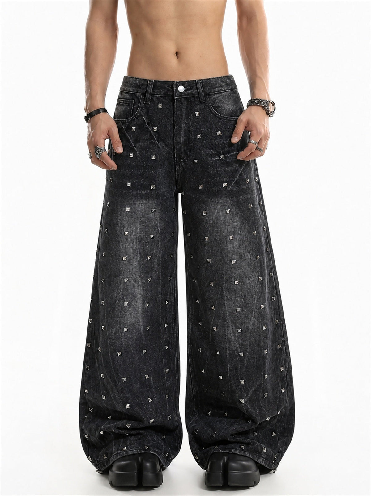 Studded washed black baggy jeans shown from the front