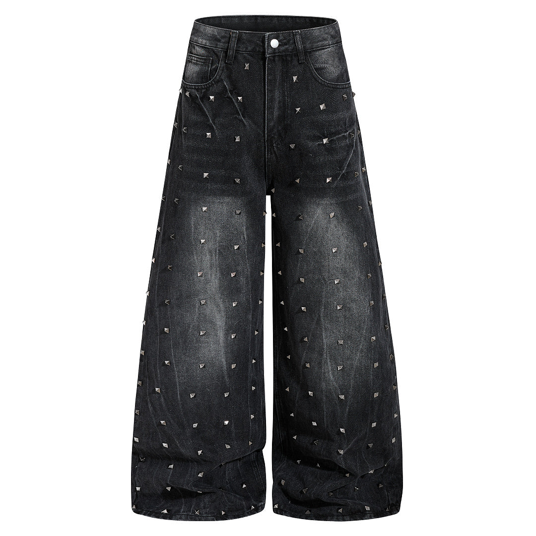Front view of washed black baggy jeans with studded detailing