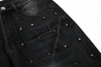 Rear pocket detail on studded washed black jeans