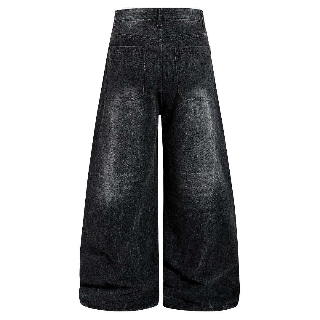 Full-length view of relaxed studded washed black jeans