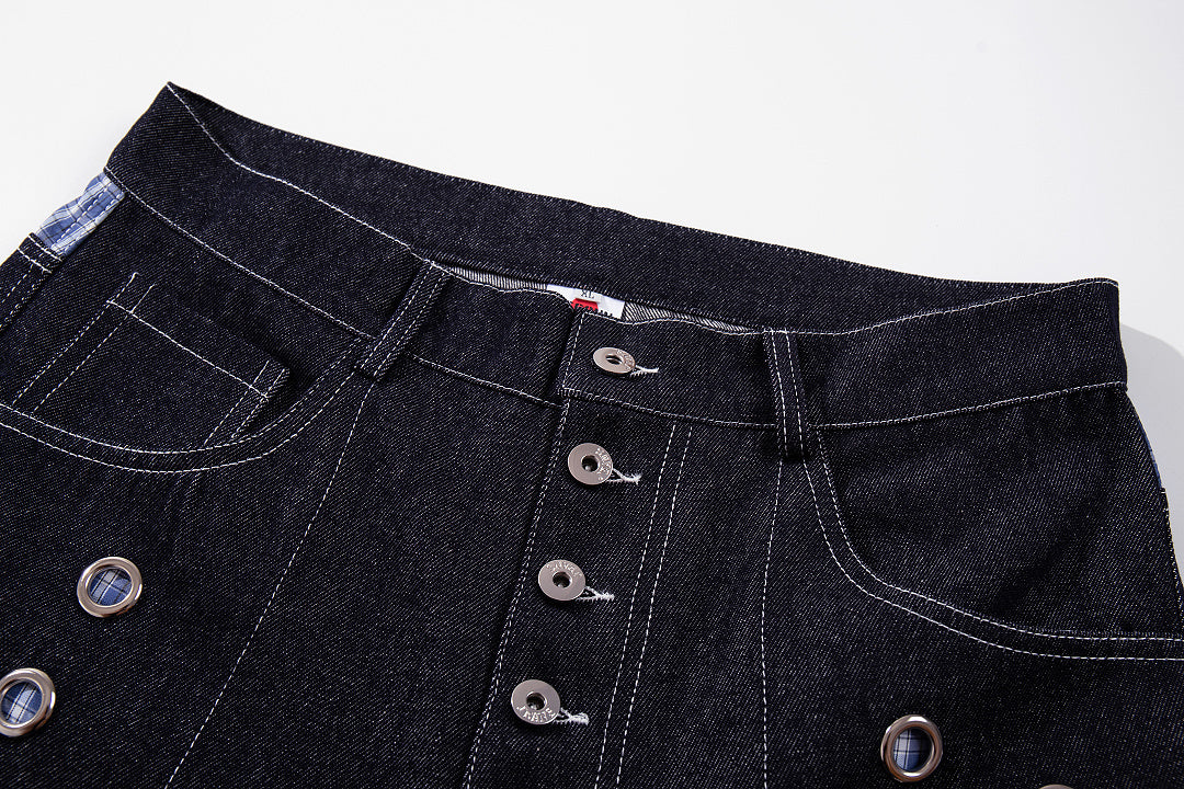 Close-up of the button fly and grommet detail on the jeans