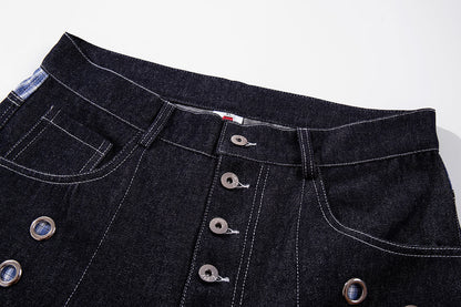 Close-up of the button fly and grommet detail on the jeans