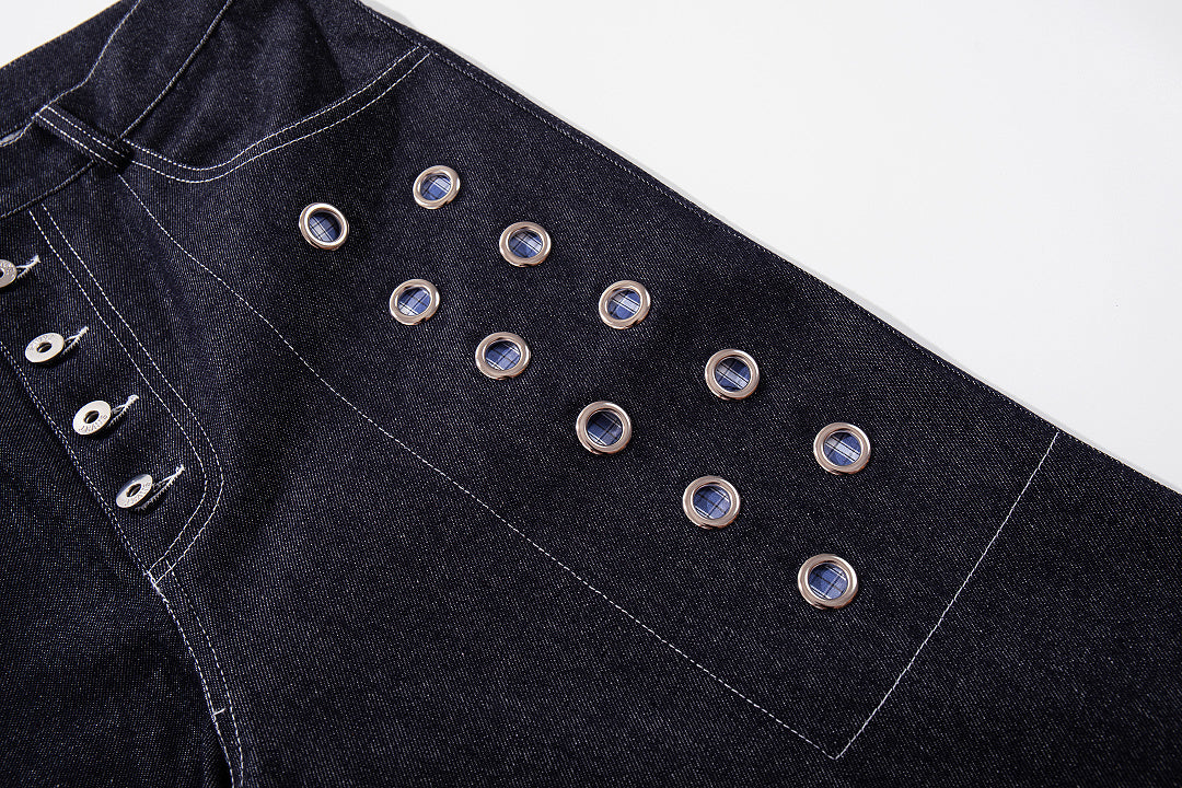 Side view of grommet baggy jeans showing the loose leg shape