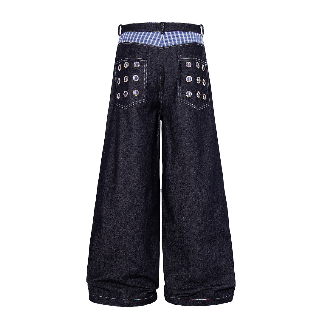 Detailed view of the grommet embellishments on the jeans