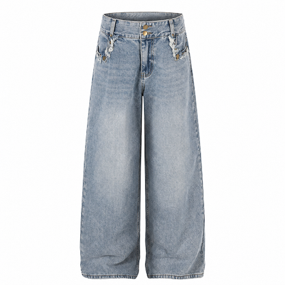 Close-up of the frayed hem on washed wide-leg jeans