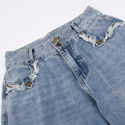 Washed denim jeans with a loose fit and distressed frayed detailing