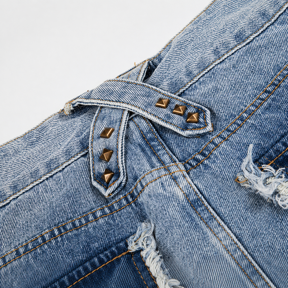 Detail view of the washed denim texture and frayed jean hem