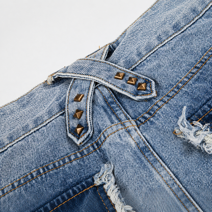 Detail view of the washed denim texture and frayed jean hem