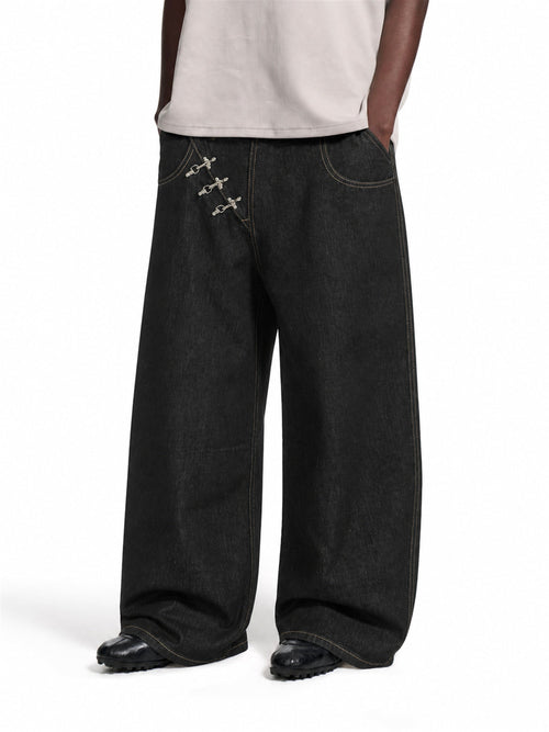 Baggy jeans with metal fireman clasps shown from the front