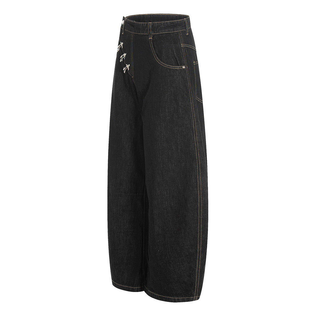 Close-up of the metal fireman clasps on the baggy jeans