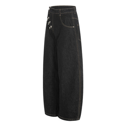 Close-up of the metal fireman clasps on the baggy jeans