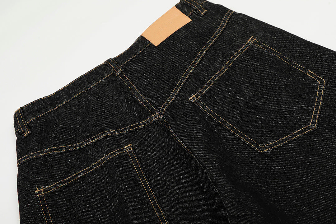 Detail of the waistband and metal clasp fastening on the jeans