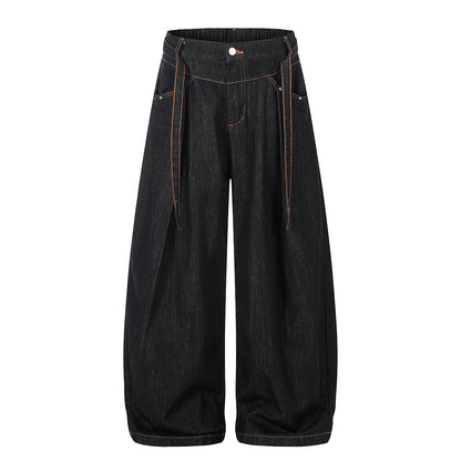 Pleated baggy barrel jeans showing the relaxed streetwear fit