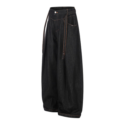 Side view of relaxed pleated barrel-leg jeans